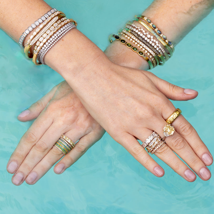 Closeup of yellow gold diamond wrist and hand candy from Shop the Look Topanga Canyon in swimming pool; 323-404-2959 for shop help